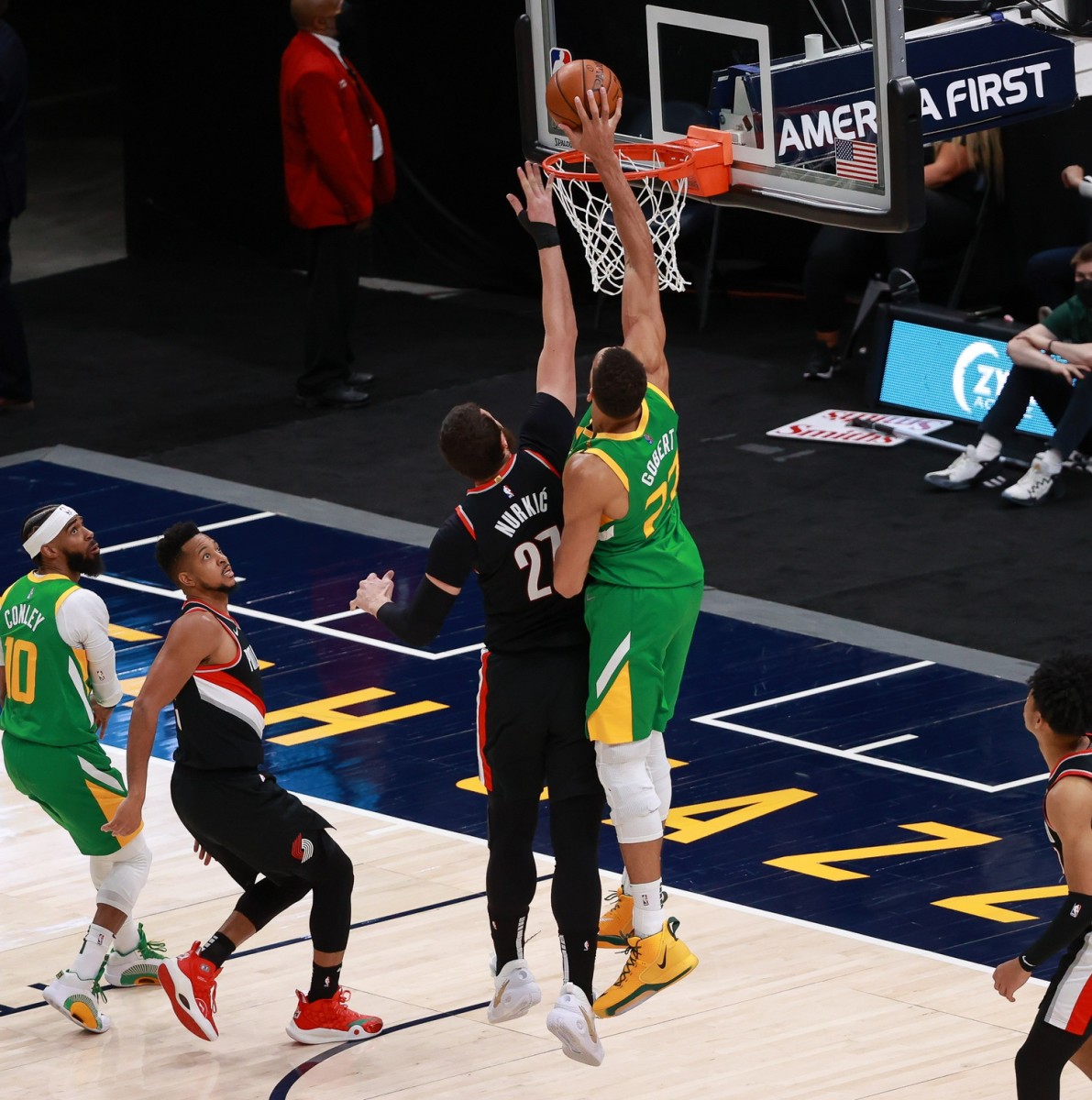 Rudy Gobert (Green #27) skies for an alley-oop over Jusuf Nurkic (Black #27)
